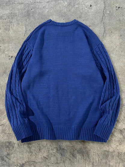 Pull unisexe automne/hiver style streetwear, en maille torsadée avec cordon de serrage, coupe ample et décontractée, col rond, épaules tombantes et manches longues.