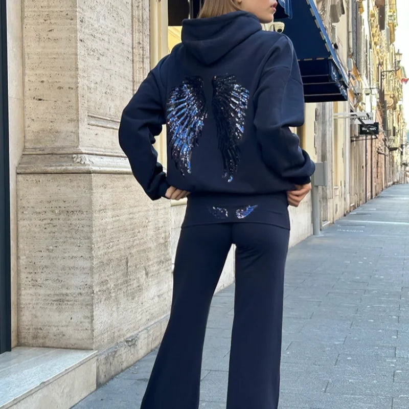 Conjunto de mulher com sweatshirt com capuz e calças compridas, modelo Free Wing, de cor lisa, novidade da moda streetwear casual 2026.